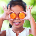 asian girl having fun to learn about vegetables with happiness